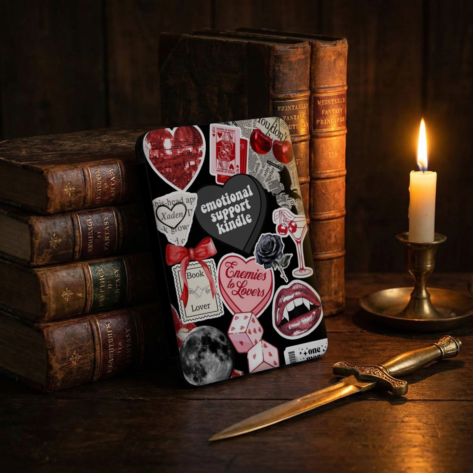 Book-themed stickers, including "Enemies to Lovers" and "Emotional Support Kindle," on a dark background.