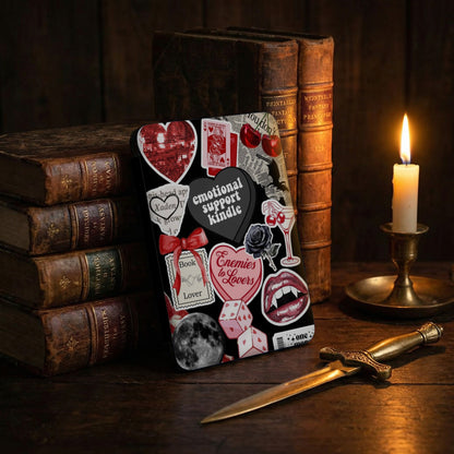 Book-themed stickers, including "Enemies to Lovers" and "Emotional Support Kindle," on a dark background.