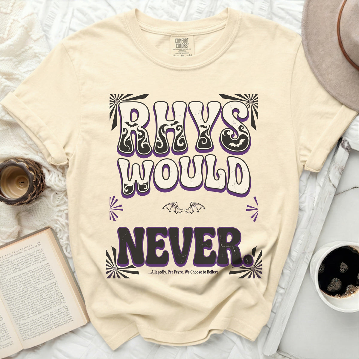 Cream t-shirt with "RHYS WOULD NEVER" and quote in purple and black text.