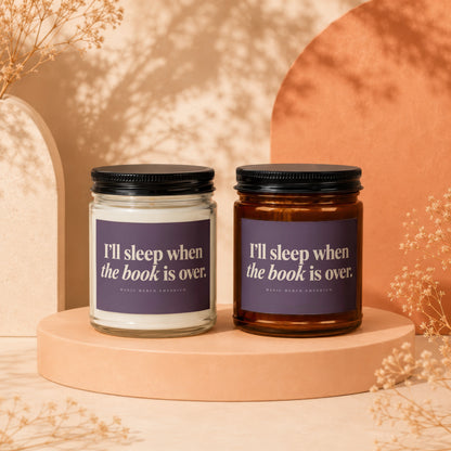 Two candles with text "I'll sleep when the book is over." and "Magic Merch Emporium".
