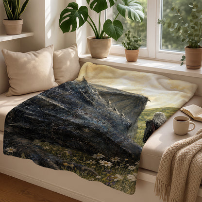 Dragon and Witcher art on a blanket displayed with plants, books, and coffee.