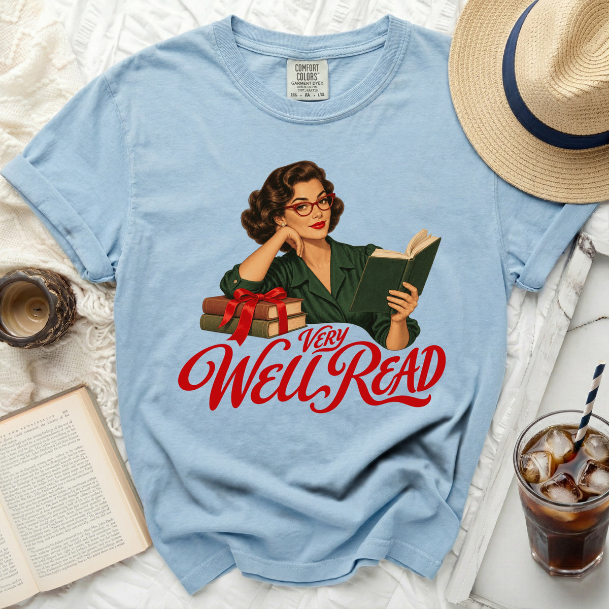 Light blue t-shirt with a retro woman reading graphic and "VERY WELL READ" text.
