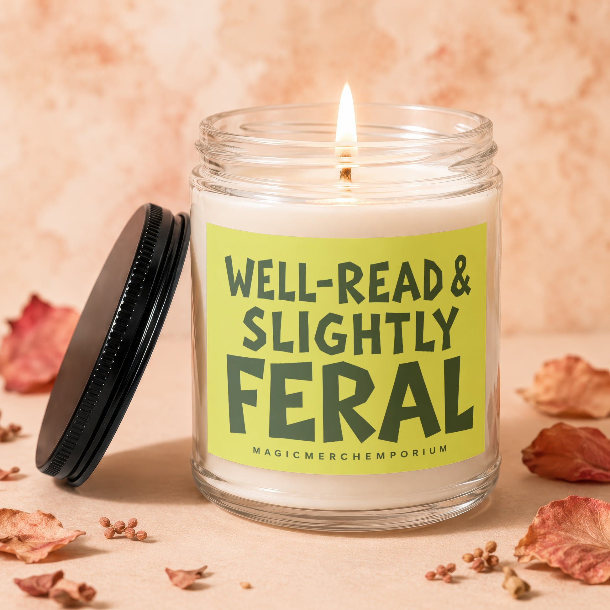 Glass candle with lit wick and the text "WELL-READ & SLIGHTLY FERAL".