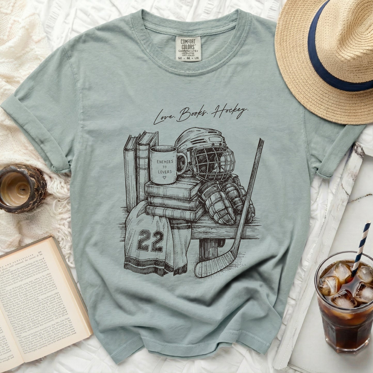 T-shirt with sketch of hockey gear and text "Love. Books. Hockey."