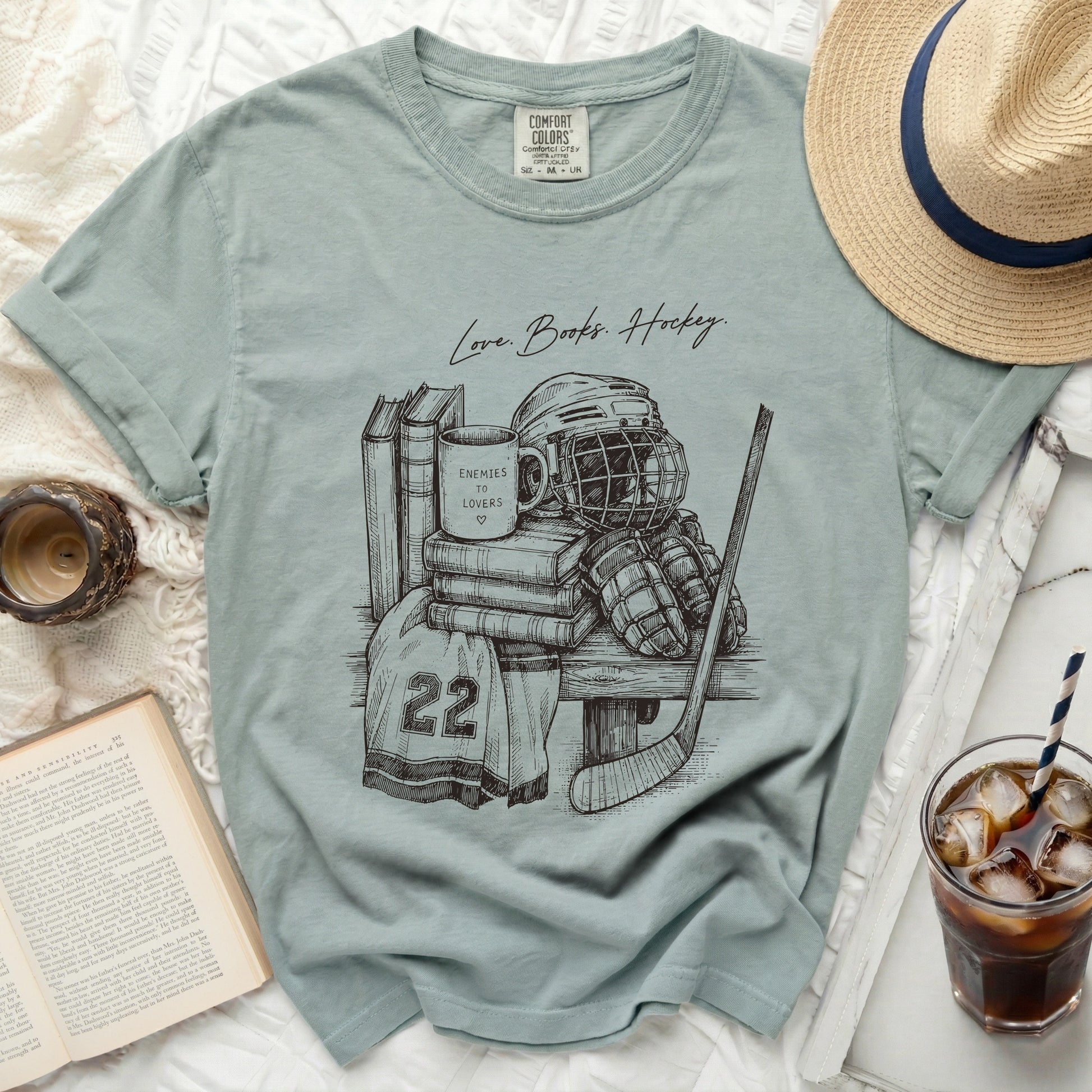 T-shirt with sketch of hockey gear and text "Love. Books. Hockey."