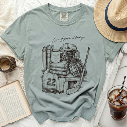 T-shirt with sketch of hockey gear and text "Love. Books. Hockey."
