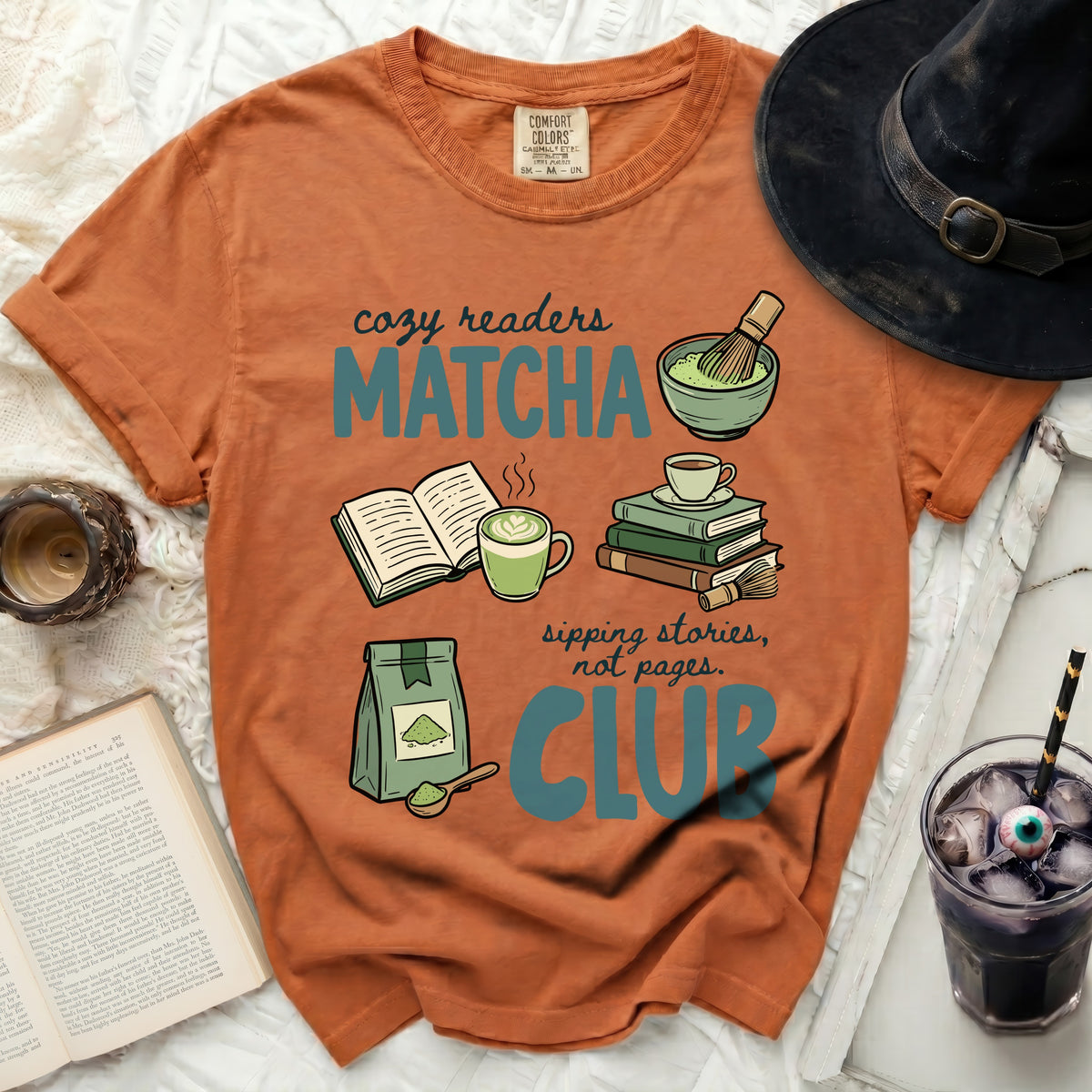 Orange t-shirt with "Cozy Readers Matcha Club" graphic, books, matcha, and a drink.