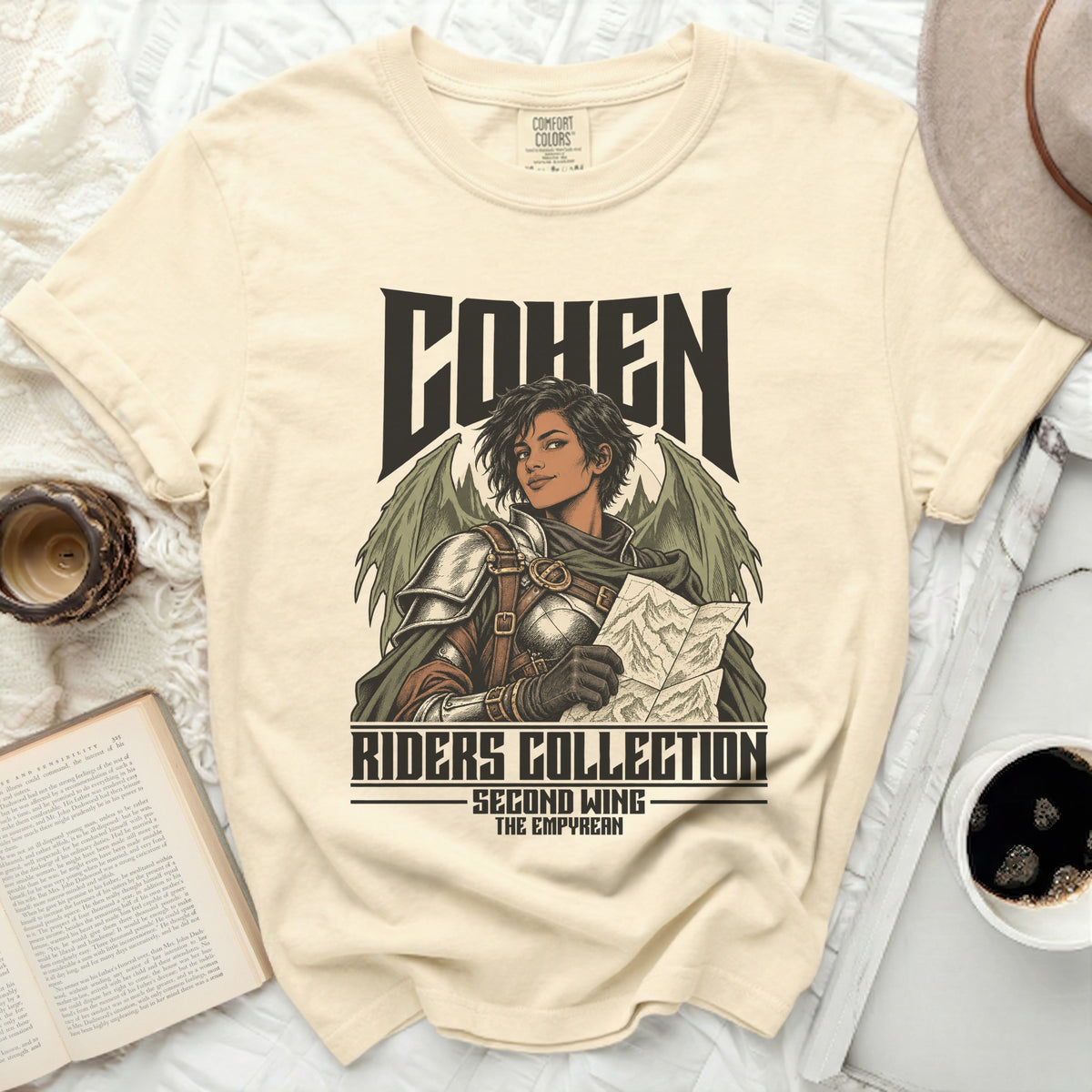 Cream t-shirt with "COHEN RIDERS COLLECTION SECOND WING THE EMPYREAN" text and a winged warrior illustration.