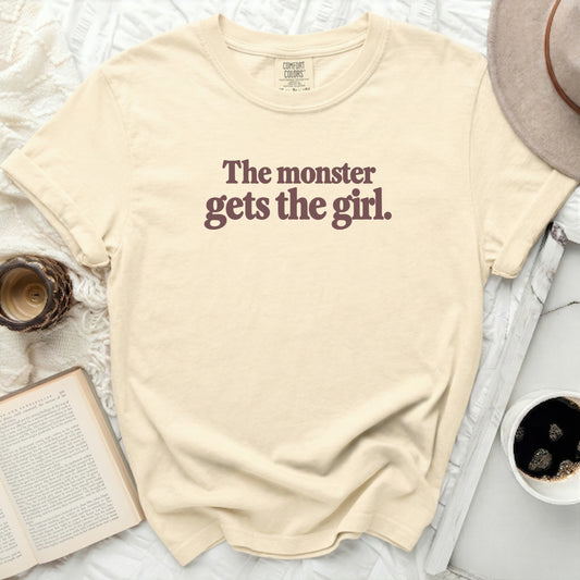 Cream t-shirt with dark text "The monster gets the girl."