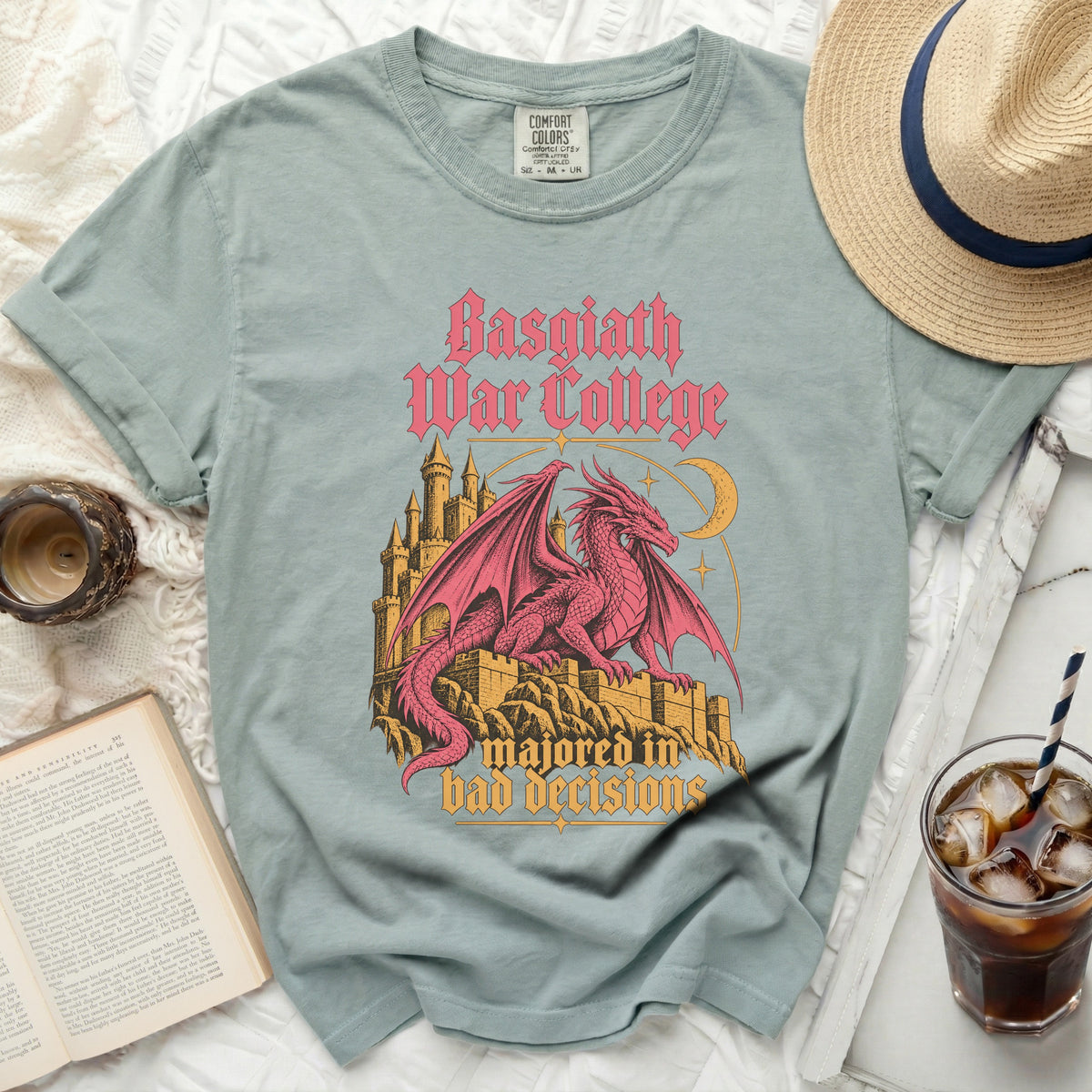 Light blue t-shirt with pink dragon, castle, and text "Basgiath War College majored in bad decisions".