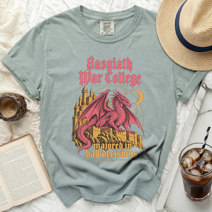 Light blue t-shirt with pink dragon, castle, and text "Basgiath War College majored in bad decisions".