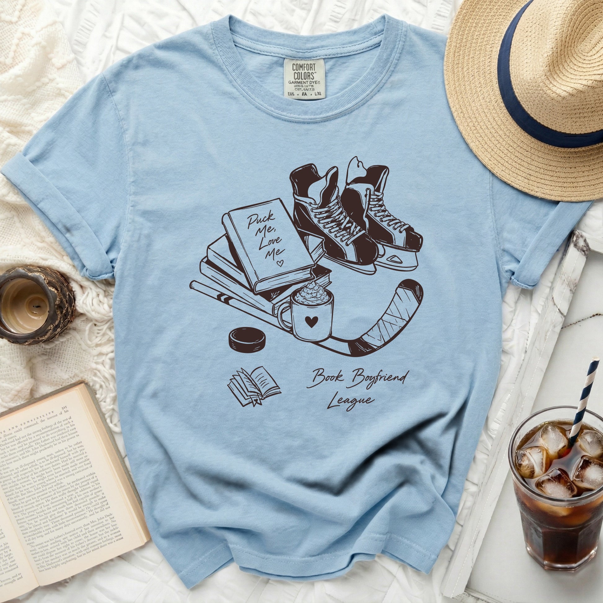Light blue t-shirt with "Puck Me Love Me" and hockey graphics.