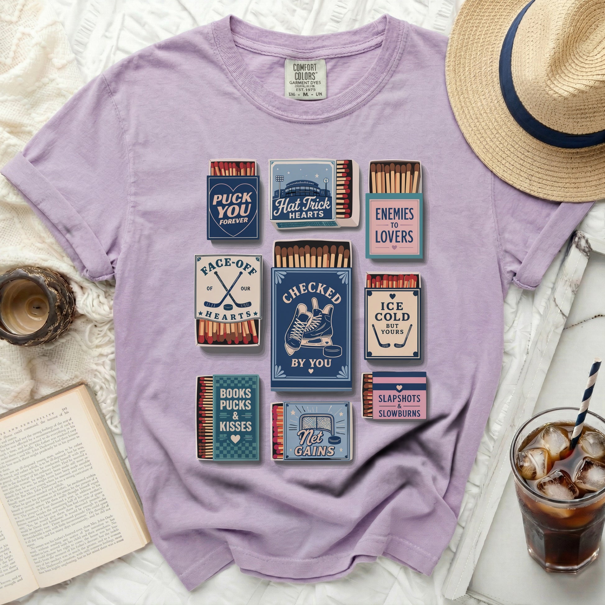 Purple t-shirt with vintage hockey-themed graphics including matchboxes and text.