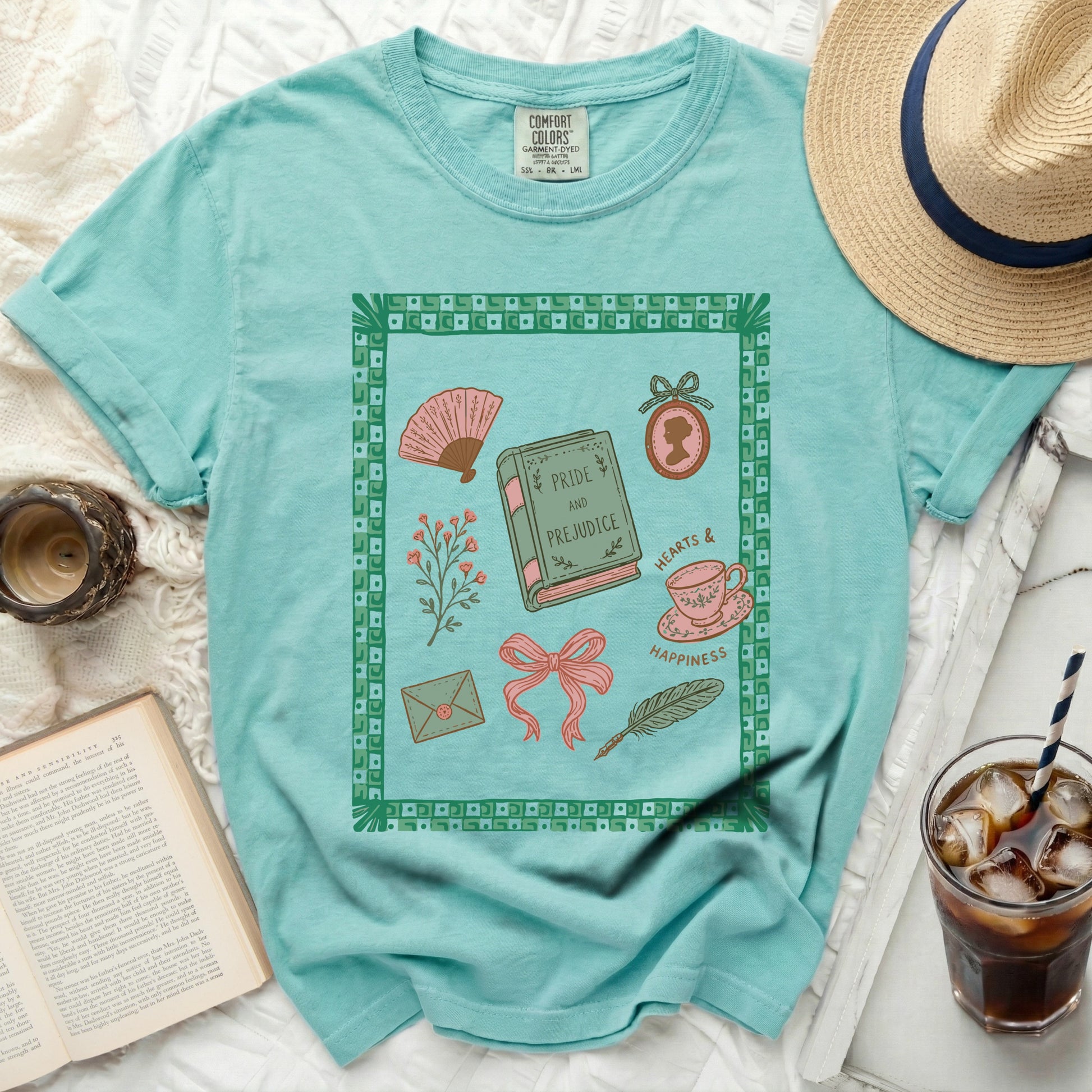 Turquoise t-shirt with "Pride and Prejudice" book and literary motifs.