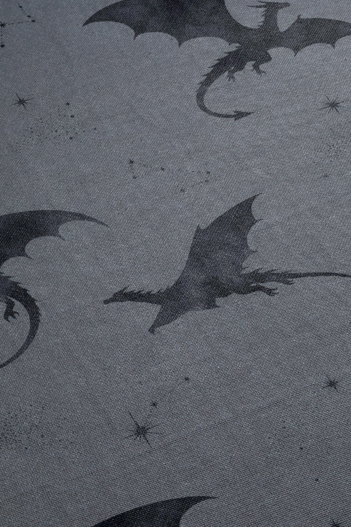 a dark, moody scene with silhouettes of dragons and stars against a dark background.
