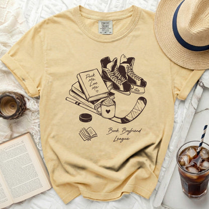 Yellow t-shirt with "Puck Me Love Me" and "Book Boyfriend League" graphics.