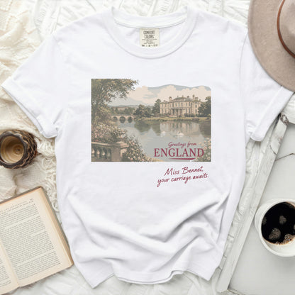 White t-shirt with England landscape illustration and cursive text.