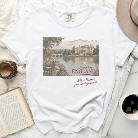 White t-shirt with England landscape illustration and cursive text.