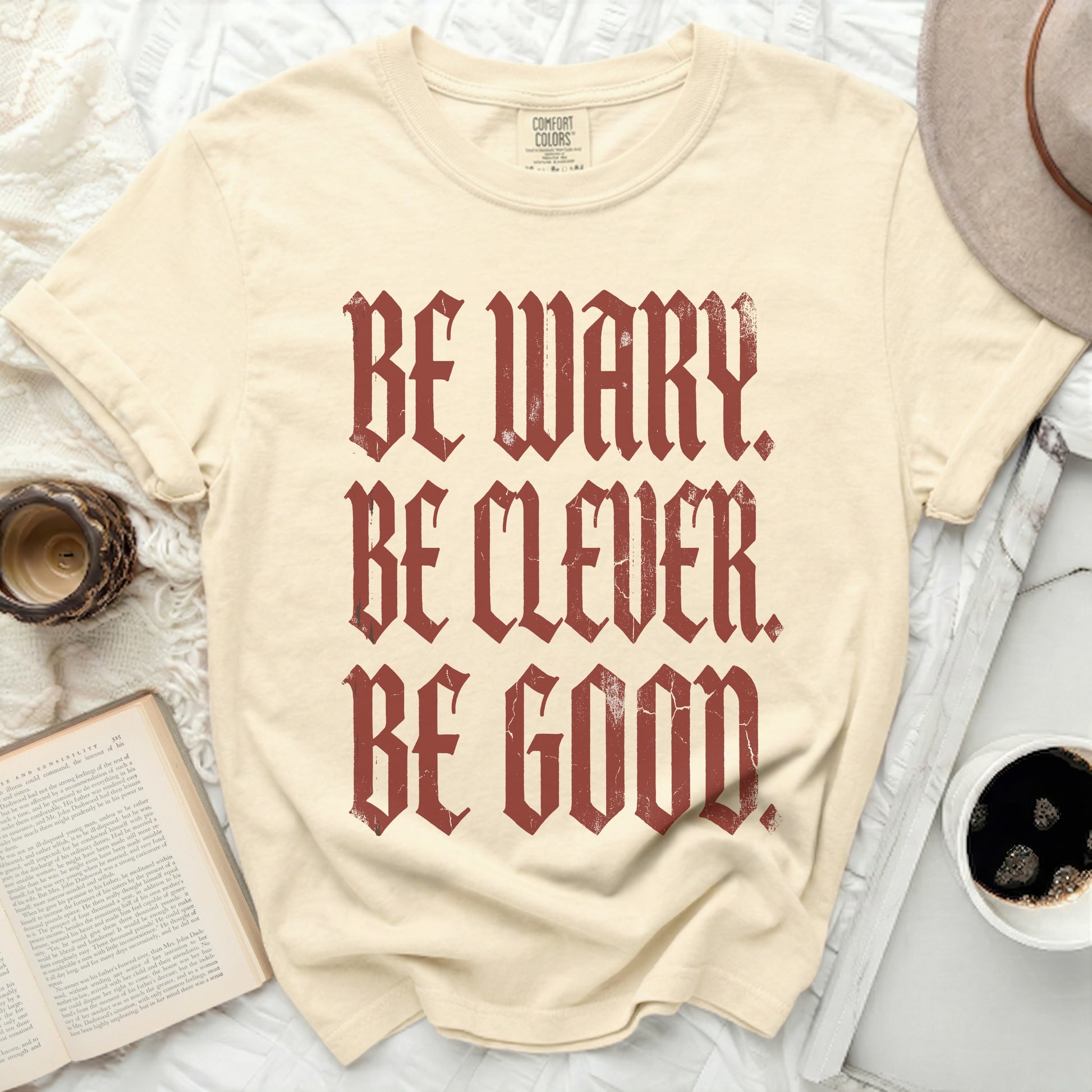 Comfort Colors t-shirt with dark red text "Be Wary. Be Clever. Be Good."