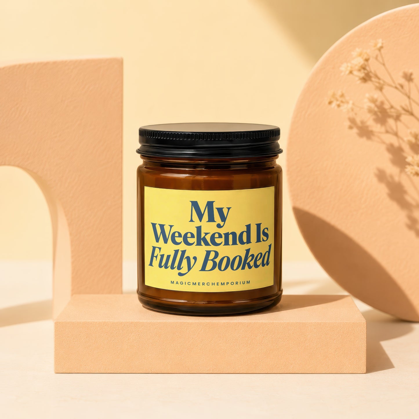 Amber glass candle with yellow label reading "My Weekend Is Fully Booked".