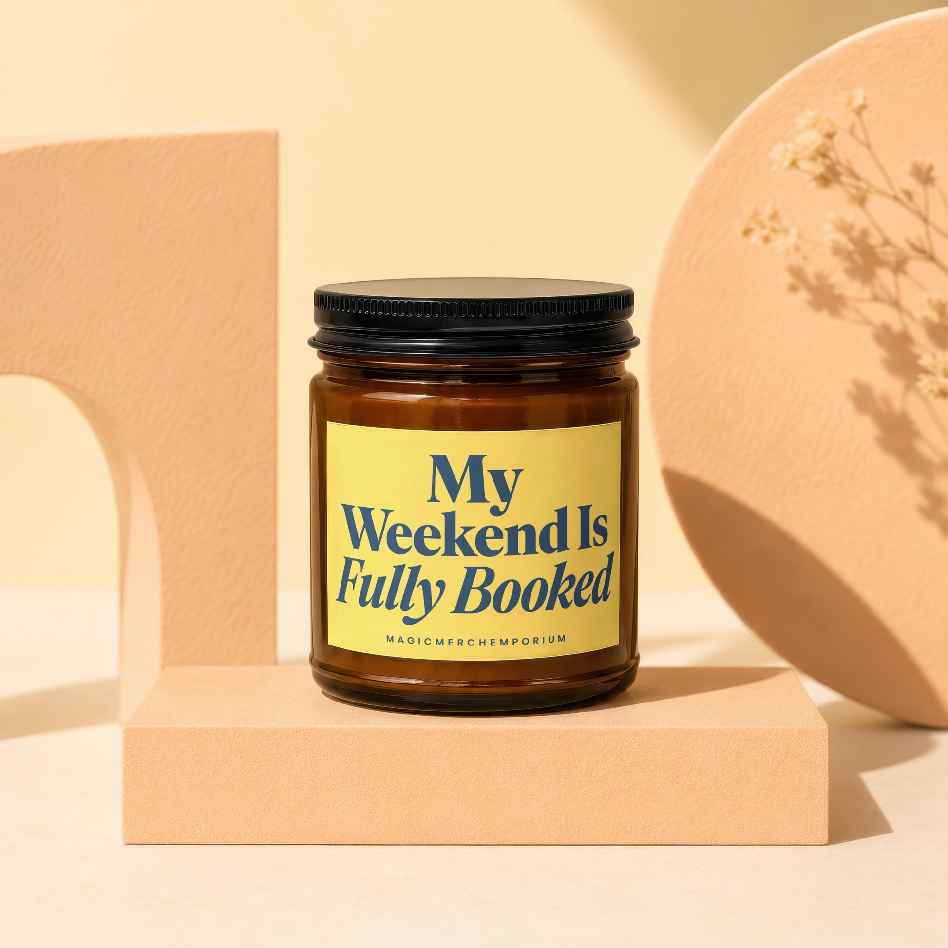 Amber glass candle with yellow label reading "My Weekend Is Fully Booked".