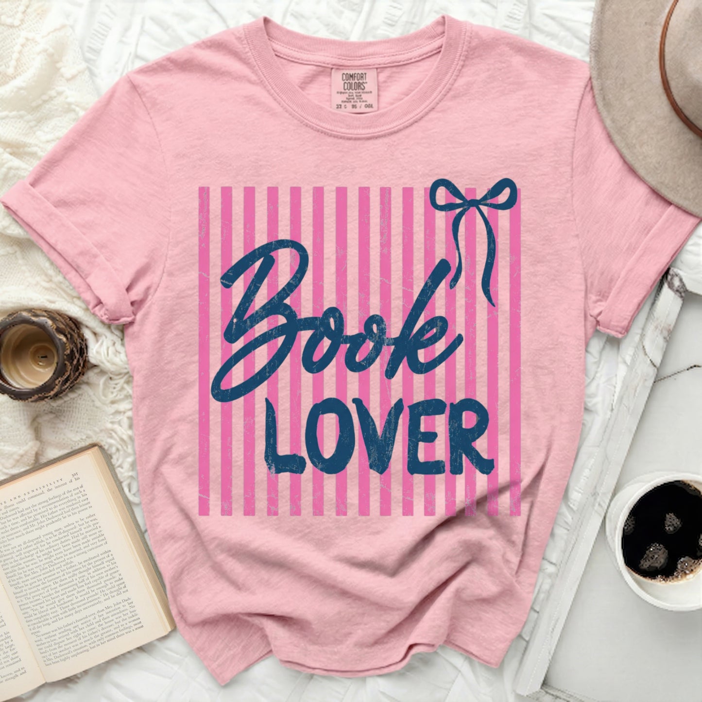 Pink t-shirt with navy blue "Book Lover" text and blue bow.