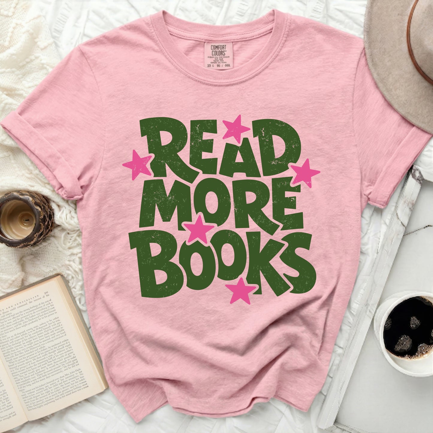 Pink t-shirt with green "READ MORE BOOKS" text and pink stars.