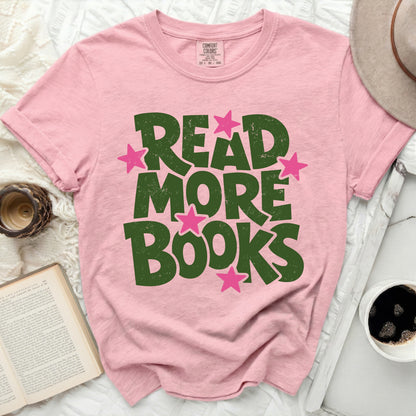 Pink t-shirt with green "READ MORE BOOKS" text and pink stars.