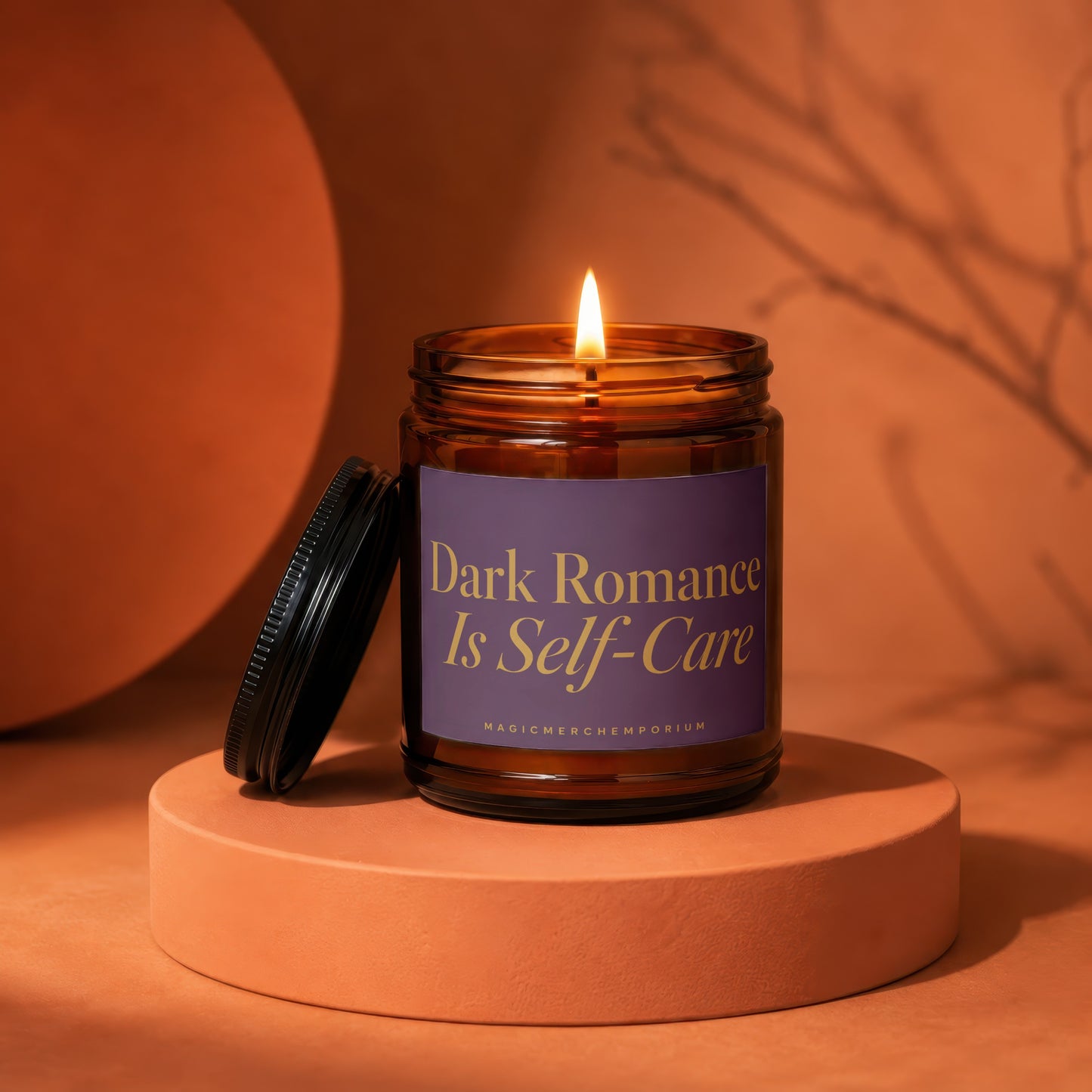 Amber jar candle with lit flame, reads "Dark Romance Is Self-Care".