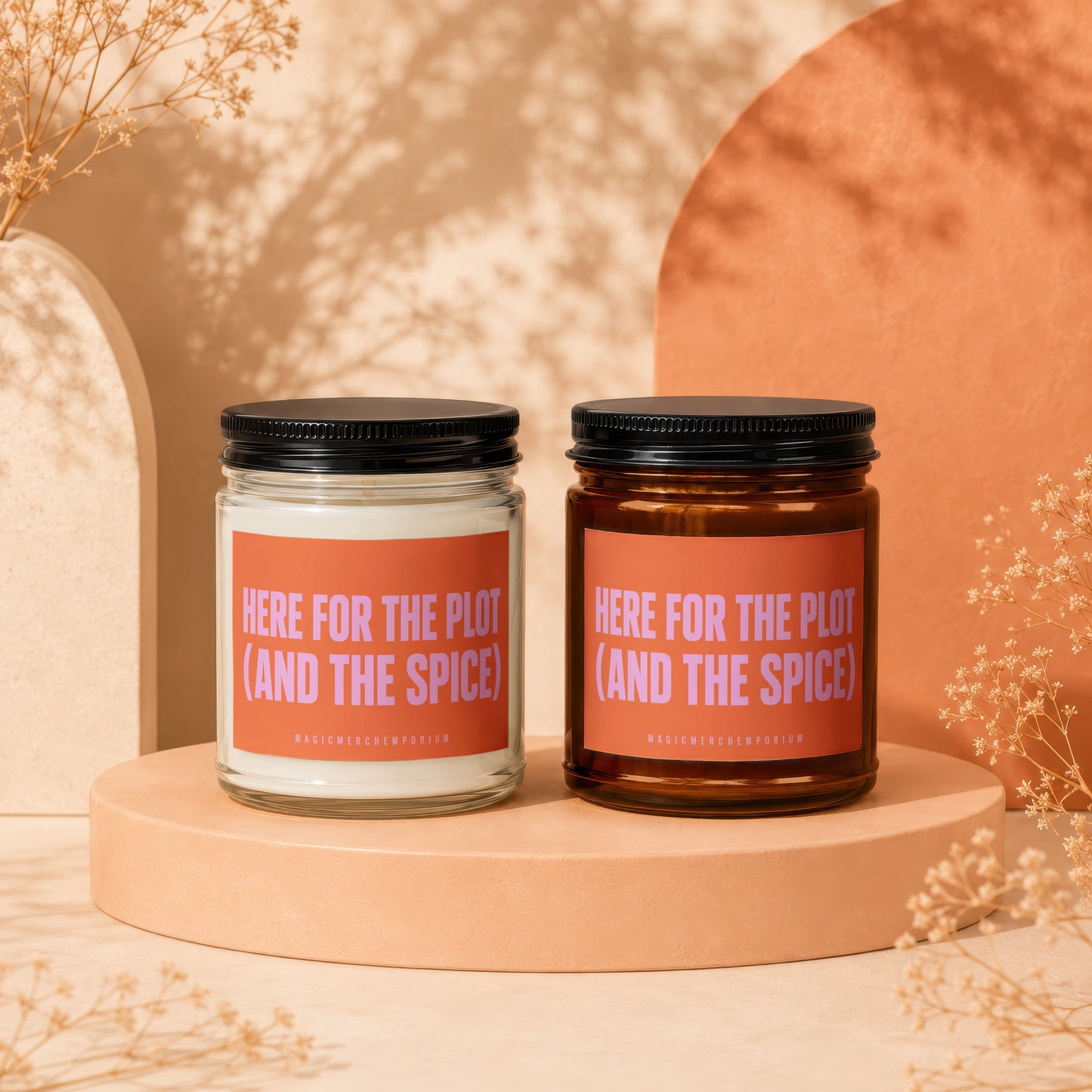 Two candles with orange labels reading "Here for the Plot (and the Spice)".