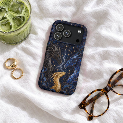 A dark blue phone case featuring three dragons and celestial patterns, resting on white fabric.