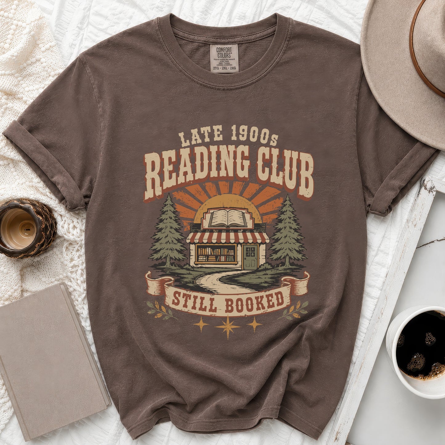 Brown t-shirt with "Late 1900s Reading Club Still Booked" graphic.