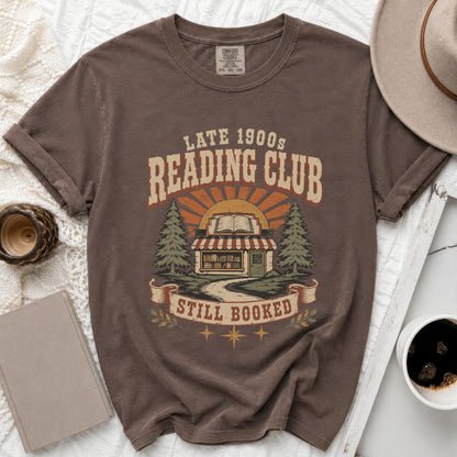 Brown t-shirt with "Late 1900s Reading Club Still Booked" graphic.