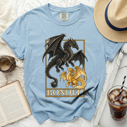 Light blue t-shirt with black and gold dragons and "BONDED" text.