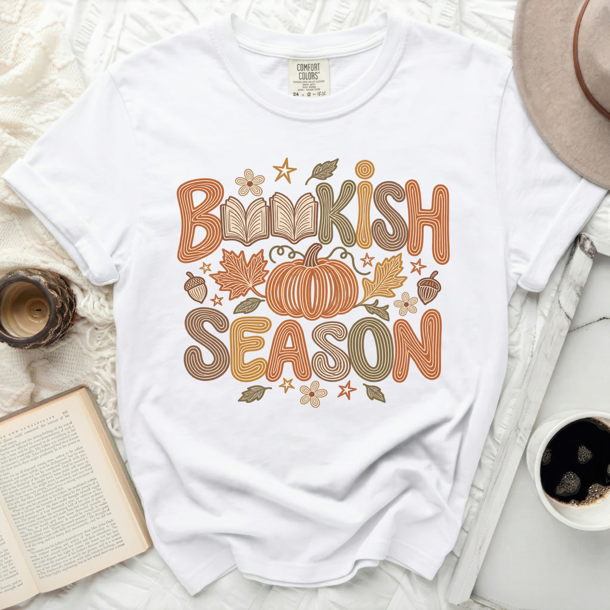White t-shirt with "Bookish Season" text, pumpkin, and fall leaves graphic.