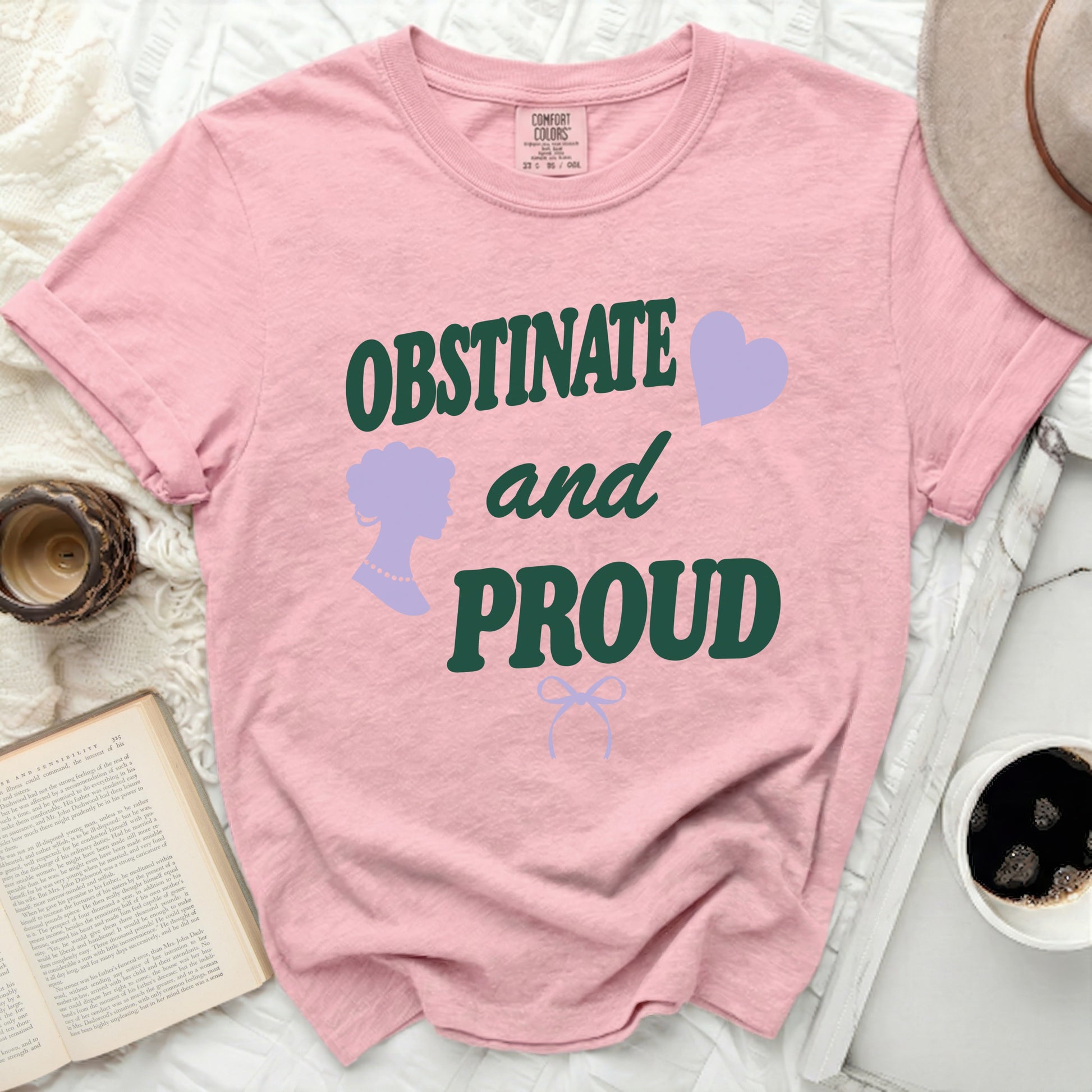 Pink t-shirt with "OBSTINATE and PROUD" text, silhouette, and heart.