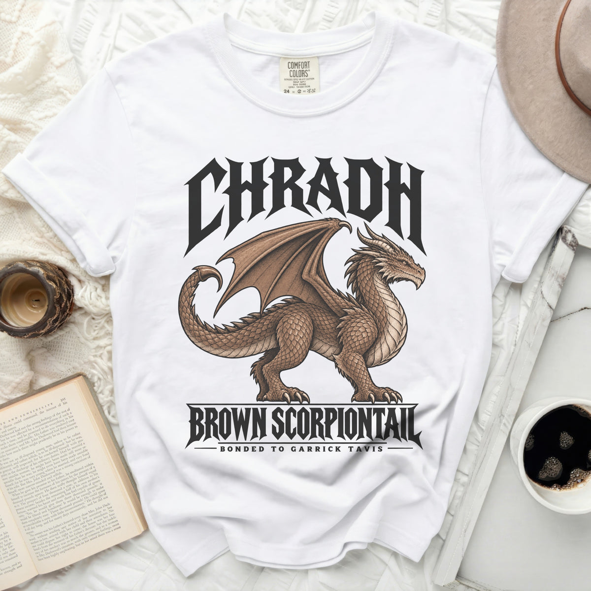 White t-shirt with brown dragon graphic and text "CHRADH BROWN SCORPIONTAIL BONDED TO GARRICK TAVIS".