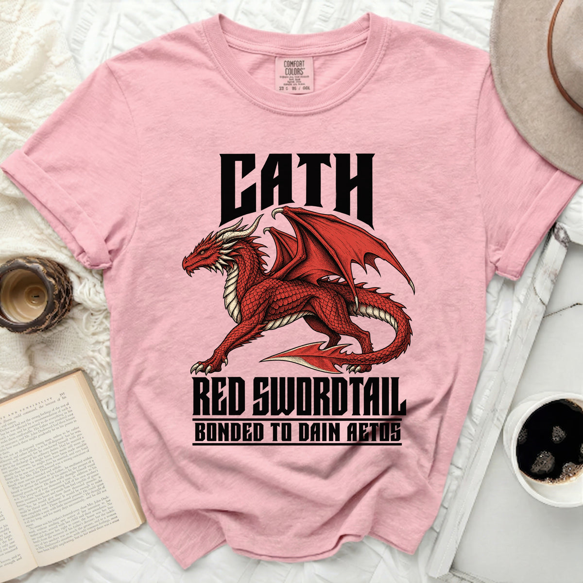 Pink t-shirt with a red dragon graphic and the text "CATH RED SWORDTAIL BONDED TO DAIN AETOS".