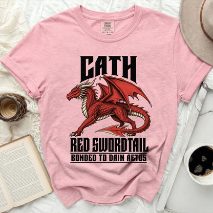 Pink t-shirt with a red dragon graphic and the text "CATH RED SWORDTAIL BONDED TO DAIN AETOS".