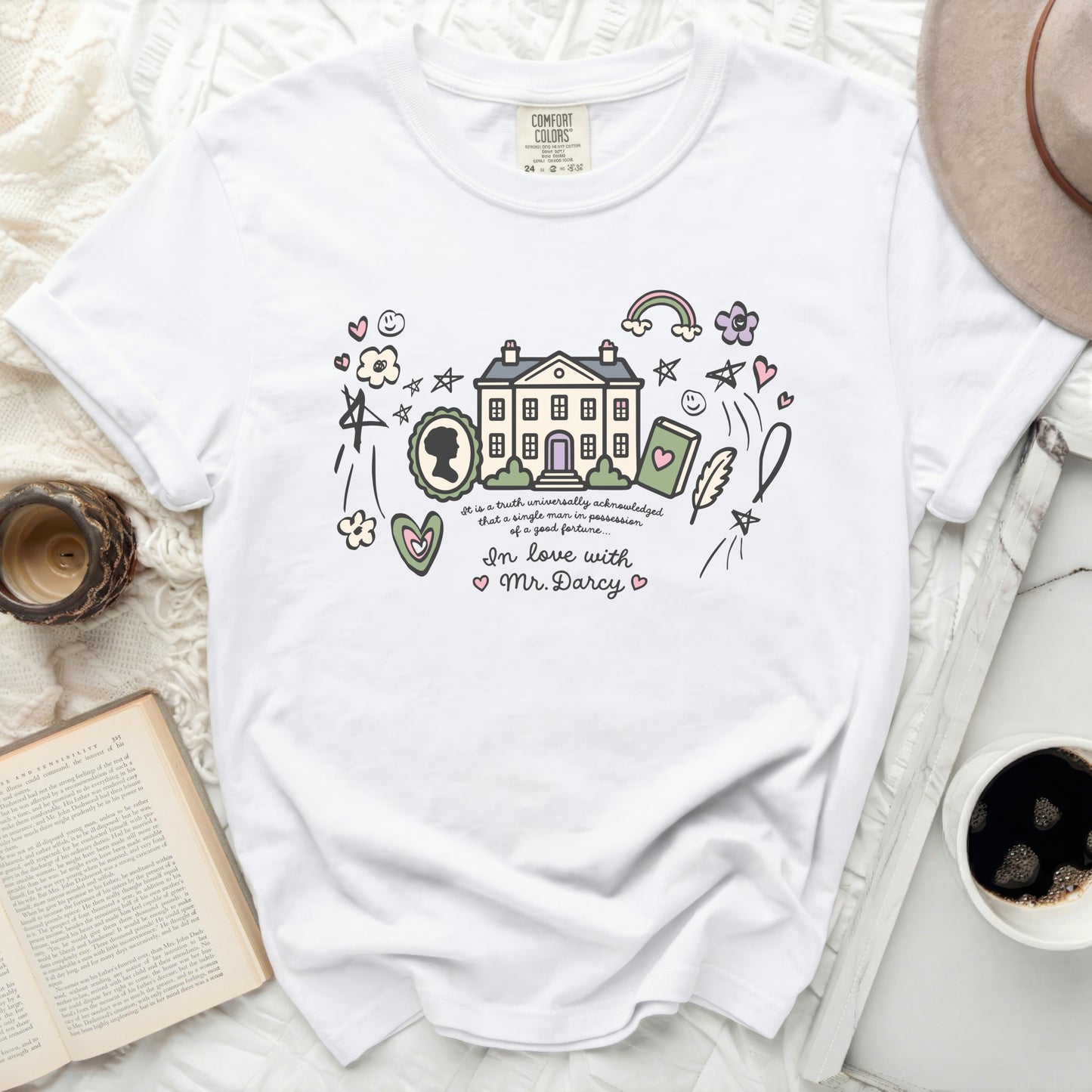 White t-shirt with "Pride and Prejudice" house illustration and text.