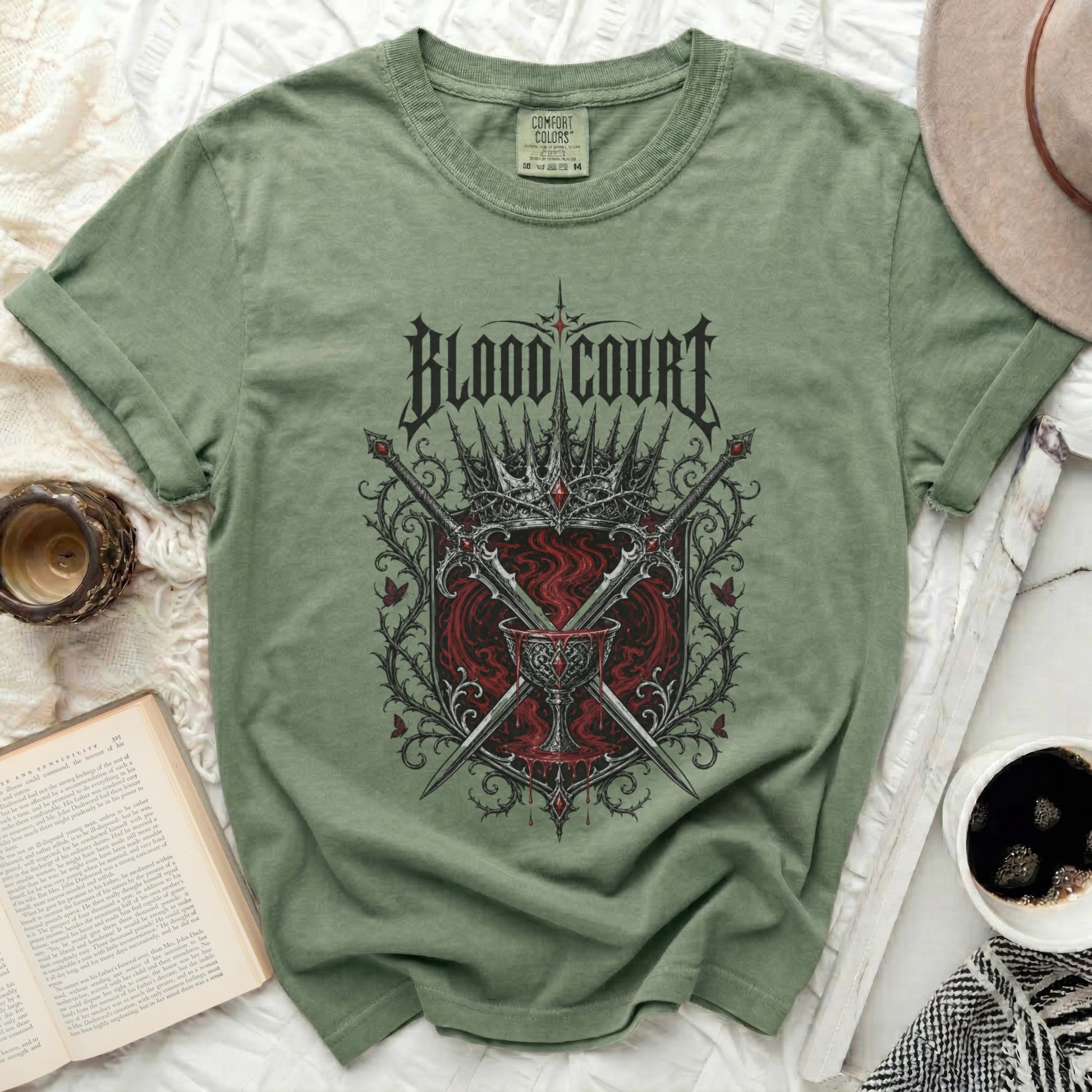 Green t-shirt with "BLOOD COURT" text, crowns, swords, and chalice graphic.