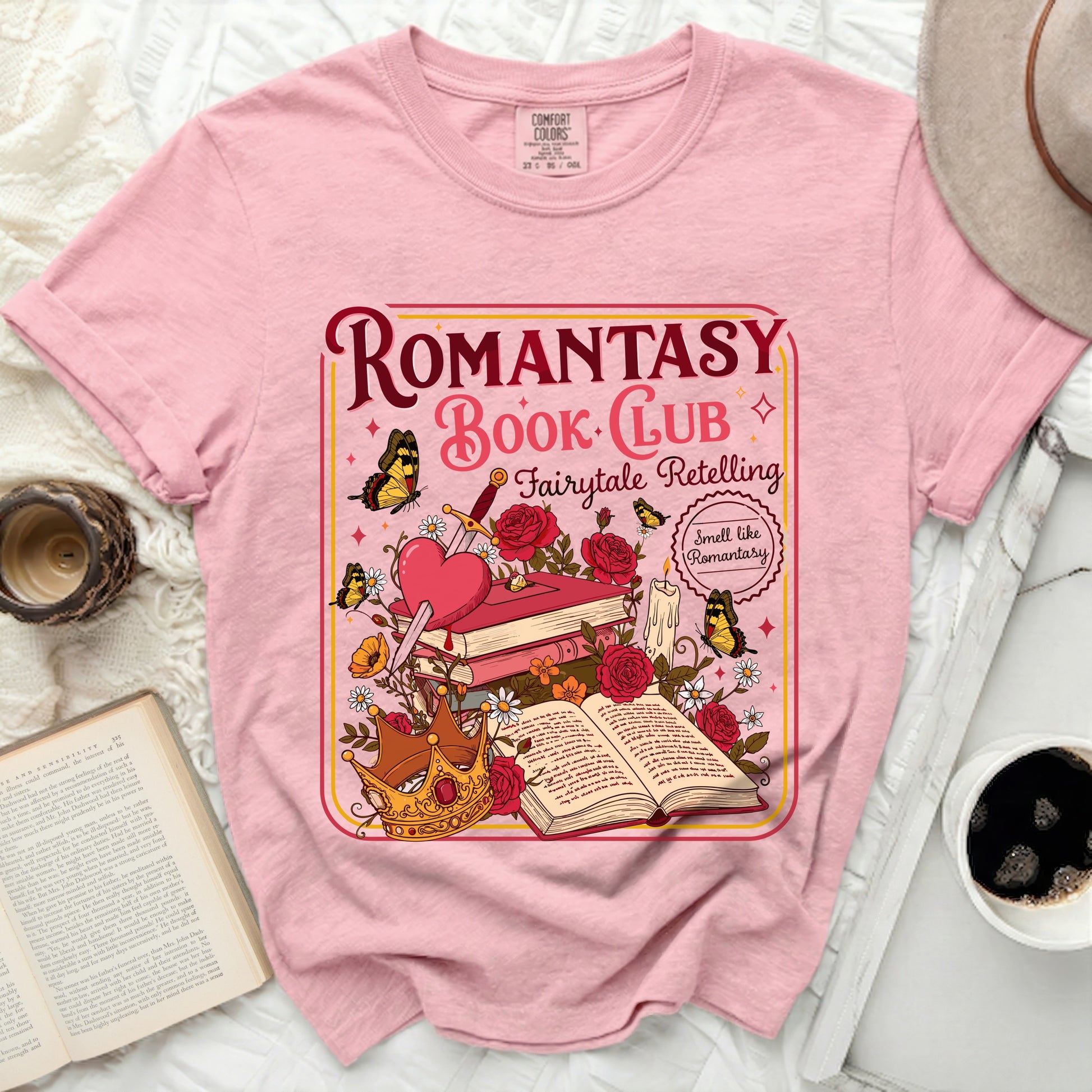 Pink t-shirt with "Romantasy Book Club Fairytale Retelling" graphic.