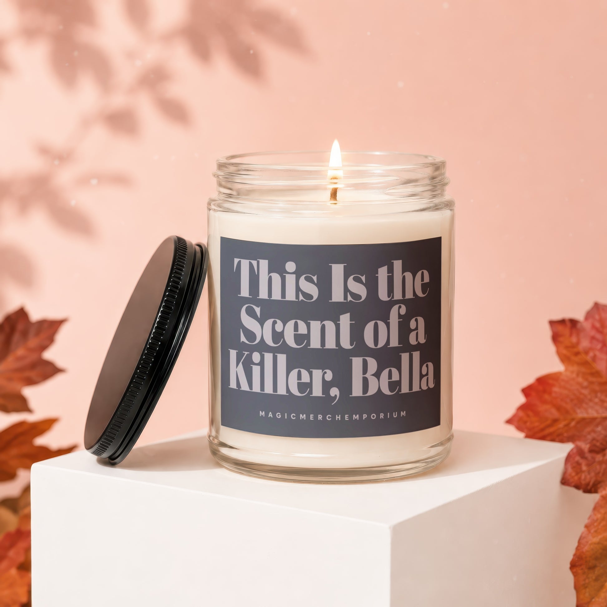 Jar candle with lit wick, "This Is the Scent of a Killer, Bella" text.