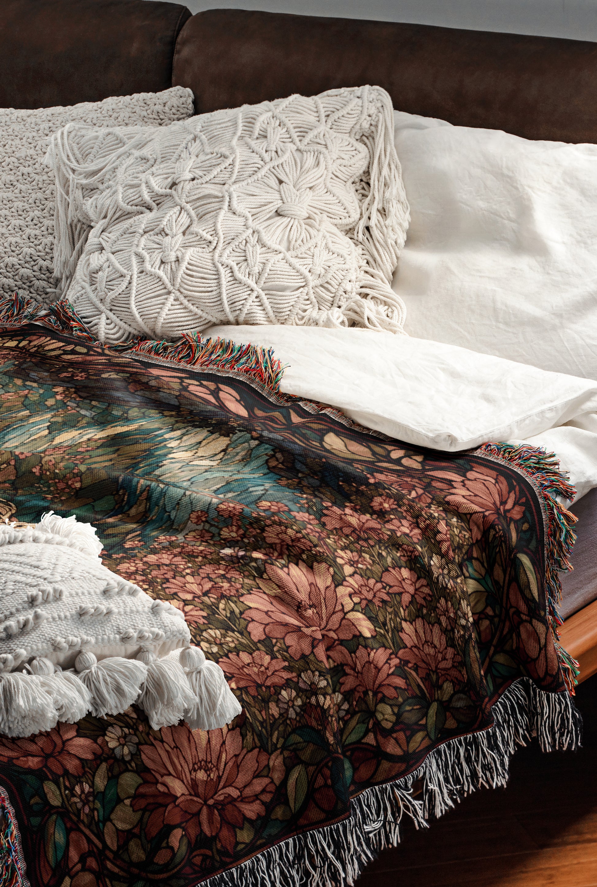 a cozy and inviting bedroom scene, featuring a bed with a floral patterned blanket and a white pillow. The bed is set against a brown leather headboard, creating a warm and comfortable atmosphere.