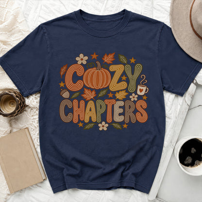 Navy t-shirt with "Cozy Chapters" text and autumn-themed graphics.