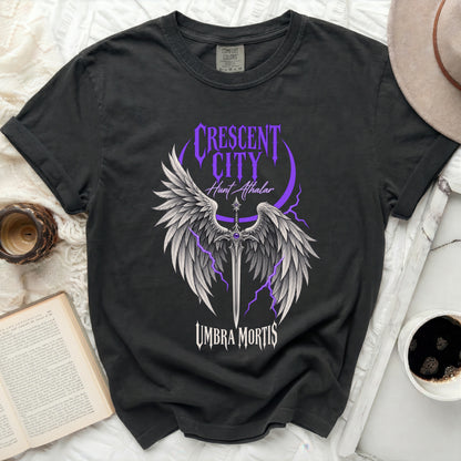 Dark t-shirt with purple "Crescent City Hunt Athalar Umbra Mortis" graphic.