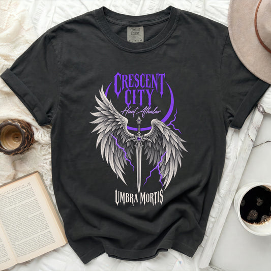 Dark t-shirt with purple "Crescent City Hunt Athalar Umbra Mortis" graphic.