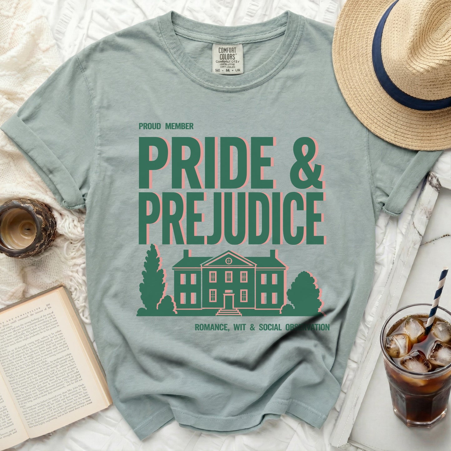 Green t-shirt with "Pride & Prejudice" text and a house illustration.