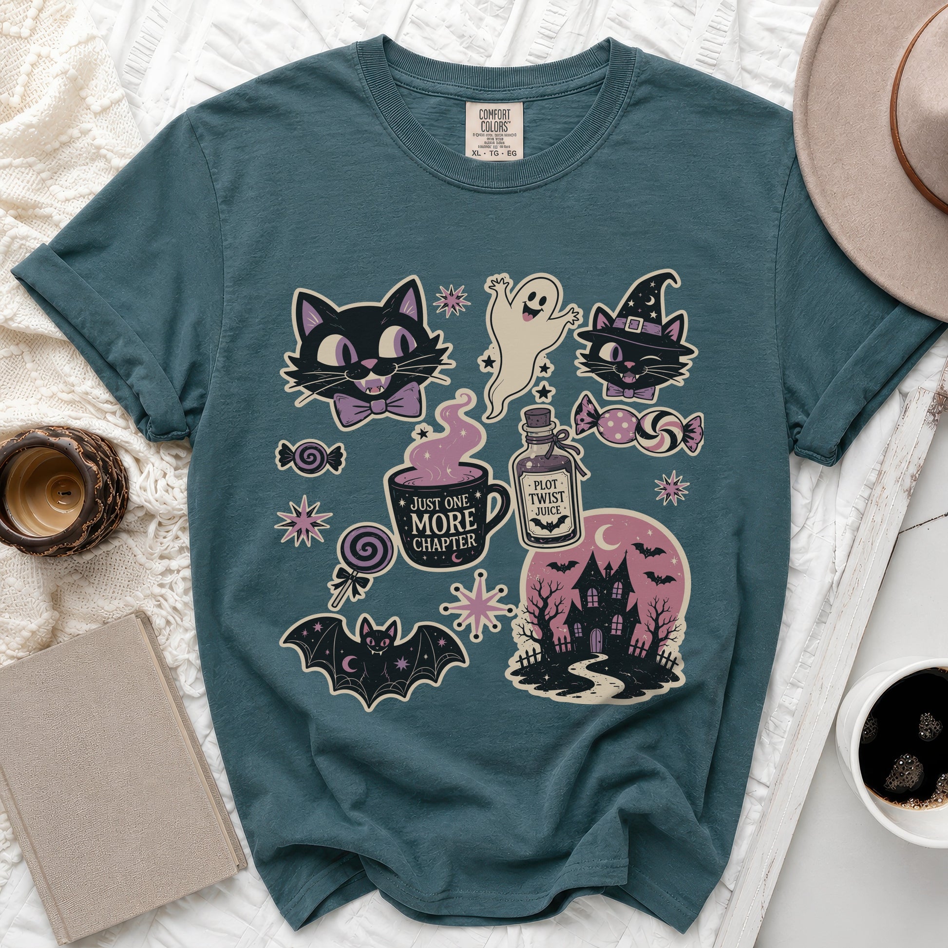 Teal t-shirt with Halloween graphics: cats, ghost, haunted house, and text.