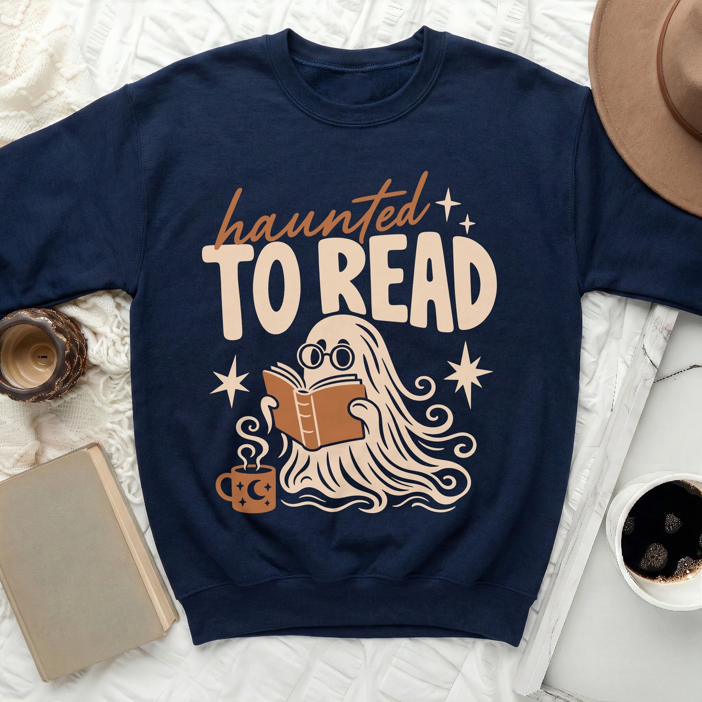 Navy sweatshirt with "haunted TO READ" text and a ghost reading a book.